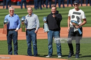 BOSTON - APRIL 13: Clutching the franchise's four Vince Lombardi Trophies, New England Patriots owners Robert Kraft, Jonathan Kraft, head coach Bill Belichick and quarterback Tom Brady were part of the pre-game ceremonies. The Boston Red Sox hosted the Washington Nationals in their home opener at Fenway Park. (Photo by Jim Davis/The Boston Globe via Getty Images)
