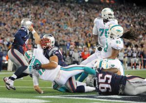 10-29 Ninkovich hits Tannehill (Photo: Keith Nordstrom Patriots.com)