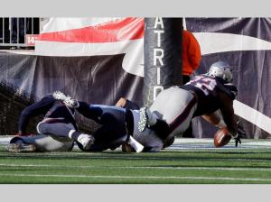 Akiem Hicks recovers the ball for a TD after it was stripped from Tennessee Titans quarterback Marcus Mariota (AP Photo/Charles Krupa)